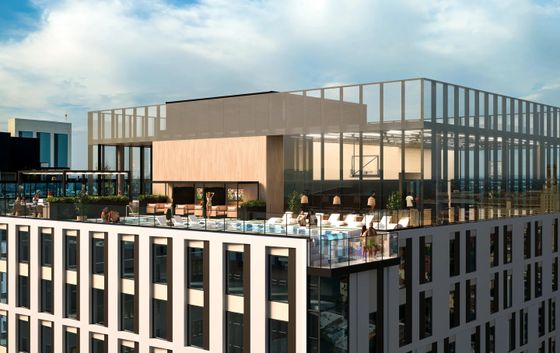 Modern rooftop features luxurious pool, chic lounge areas, and panoramic city views.