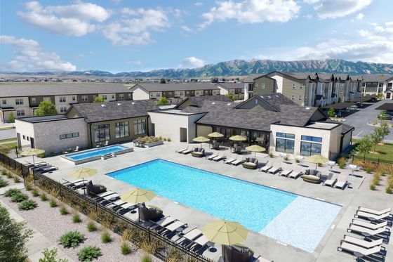 Luxurious apartment complex featuring a spacious outdoor pool area, stylish sun loungers, and scenic mountain views.