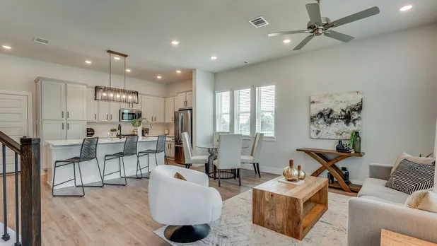 furnished and decorated living room and kitchen with wood style flooring