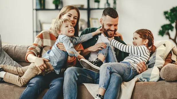 Family hugging on a couch