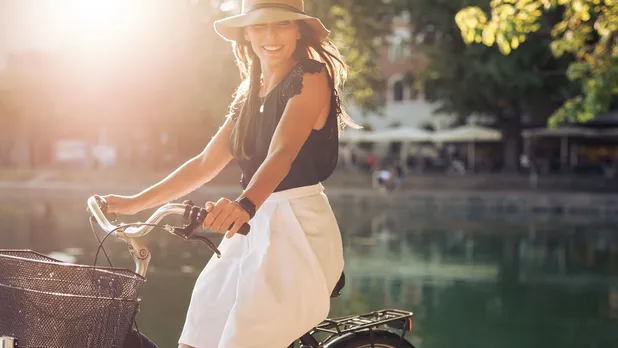 woman on a bike by a pond