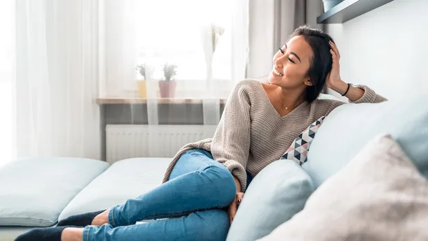 woman sitting on a couch smiling