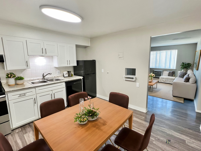 Charming open-concept apartment with a stylish kitchen, inviting dining area, and cozy living room with natural light.