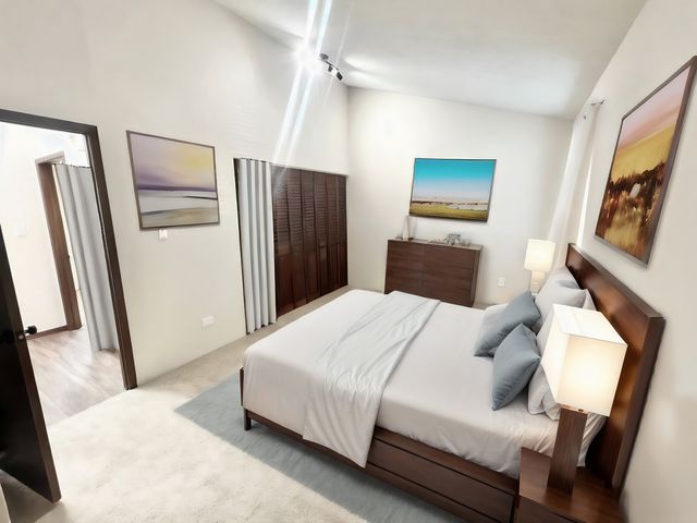 Inviting bedroom with elegant wooden furniture, cozy bed with plush pillows, and serene artwork, perfect for relaxation.