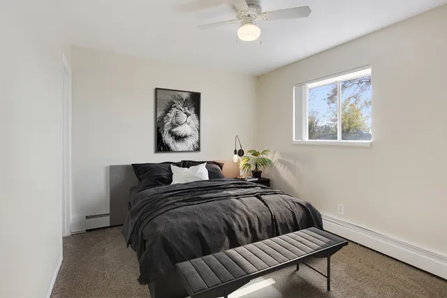 Bright bedroom with cozy double bed, stylish decor, and large window allowing natural light.