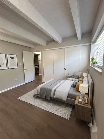 Inviting bedroom with modern decor, cozy bed, and large windows for natural light.