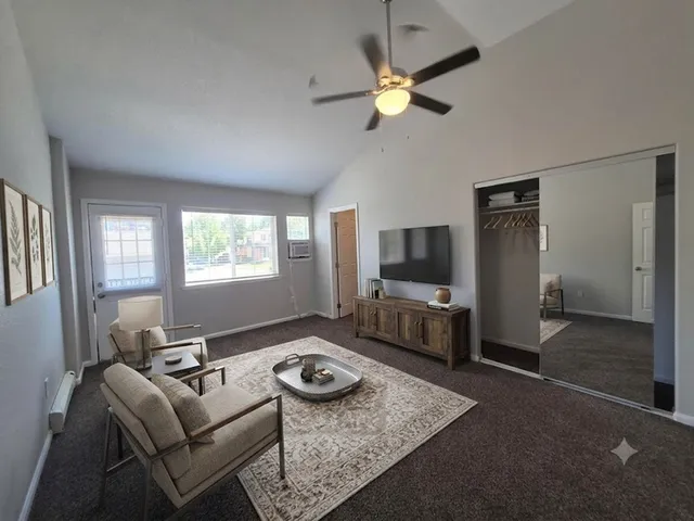 Inviting living room with plush seating, stylish decor, and abundant natural light from large windows.