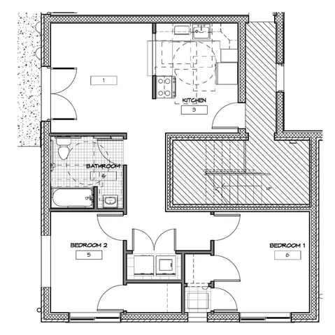 Modern floor plan showcasing 2 bedrooms, a well-equipped kitchen, and a cozy living area with a central staircase.