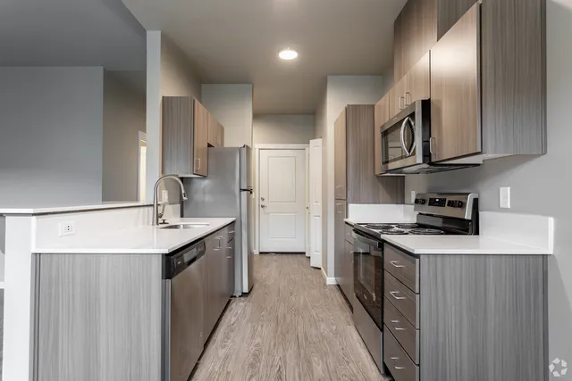 Sleek modern kitchen featuring stainless steel appliances, elegant cabinetry, and pristine countertops.