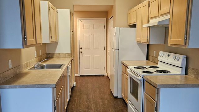 Bright and inviting kitchen with ample cabinetry, modern appliances, and stylish countertops offering functionality and elegance.