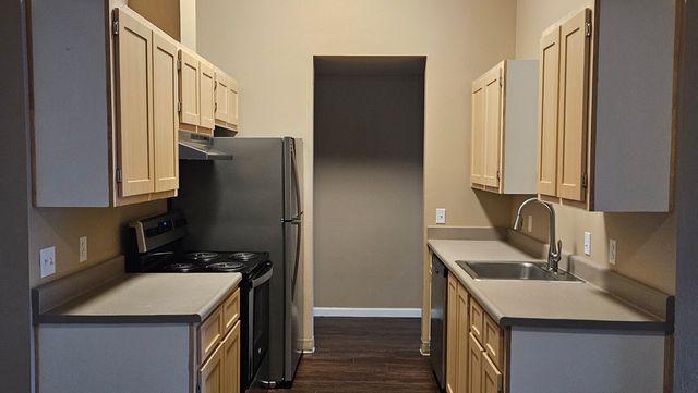 Modern kitchen with sleek stainless steel appliances, ample cabinetry, and elegant countertops, ideal for culinary enthusiasts.