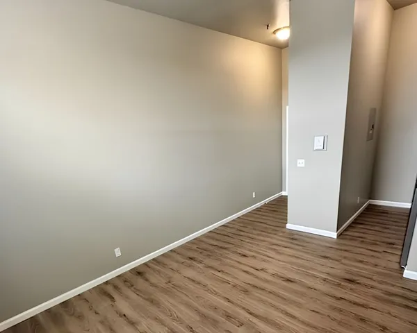 Modern apartment interior showcasing elegant hardwood floors and freshly painted walls, perfect for a stylish living space.