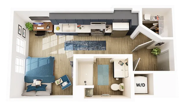 Modern open-concept studio apartment featuring a spacious kitchen with blue cabinetry, cozy bedroom area, chic home office setup, and stylish bathroom.