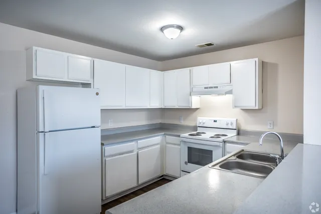 3-bedroom kitchen with white cabinets and appliances at Meadows West Memphis Apartments in West Memphis, AR