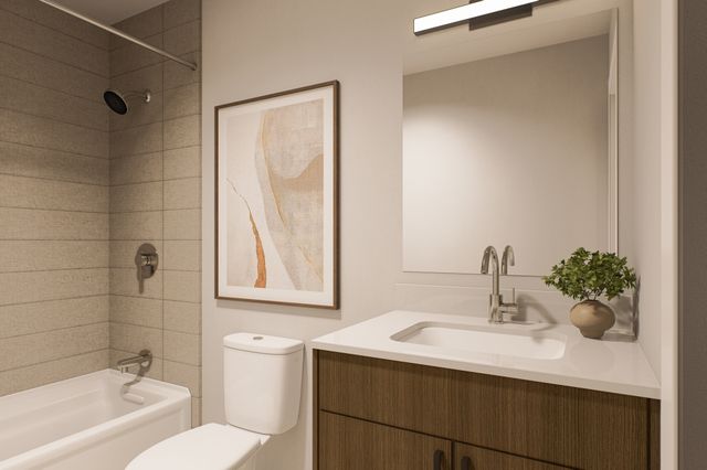 Modern bathroom with sleek fixtures, elegant bathtub, stylish vanity, and contemporary wall art, creating a serene and inviting atmosphere.