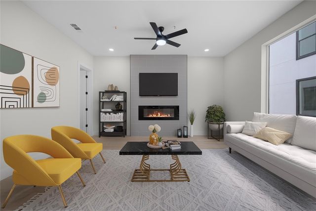 Modern living room with sleek fireplace, cozy beige sofa, and stylish yellow chairs offering a warm, inviting atmosphere.
