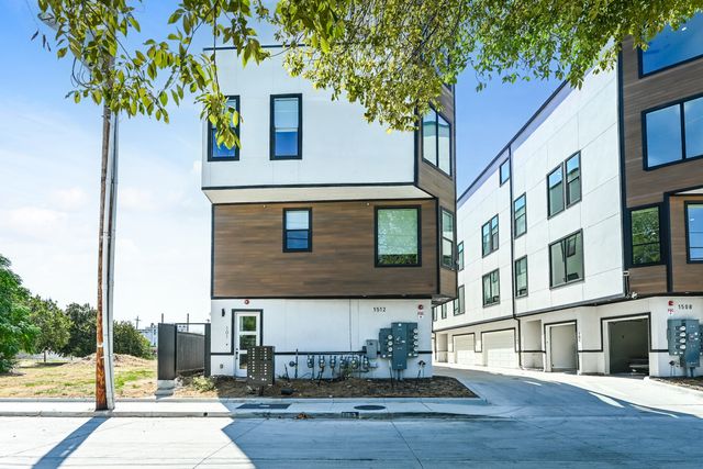 Modern multi-level apartment building with contemporary design, featuring sleek lines and large windows, set amidst a vibrant urban environment with lush greenery.