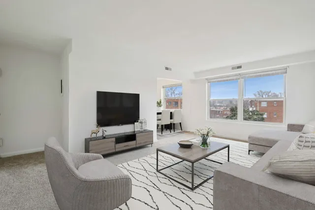 Inviting living room with modern furniture, large windows, and natural light.
