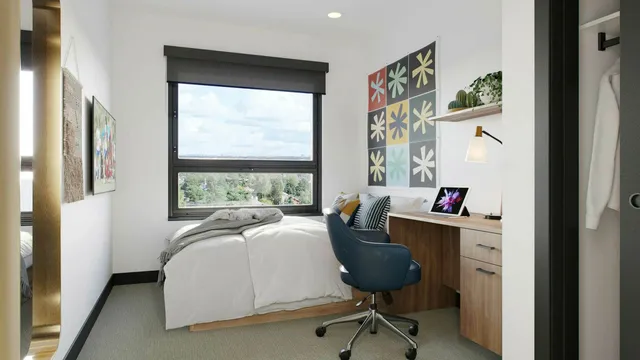 Bright and modern bedroom with a large window view, cozy workspace, and stylish decor, perfect for comfort and productivity.