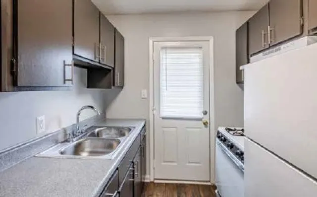 Charming galley kitchen with sleek cabinets, modern appliances, and abundant natural light. affordable rent