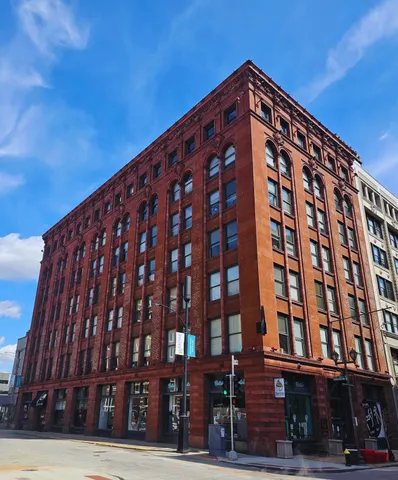 Stunning historic red brick apartment building with arched windows, capturing urban charm and architectural elegance