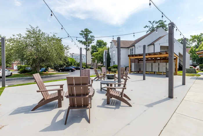 furnished pergola area with seating and mail area on sunny day