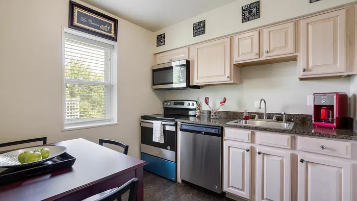 Elegant kitchen with modern appliances, stylish cabinetry, and a cozy dining area.