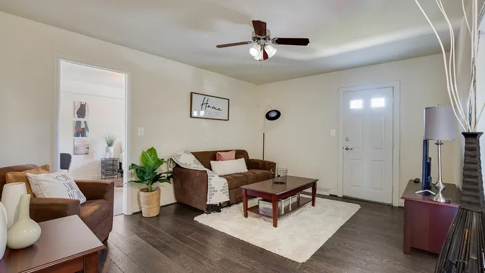 Inviting living room with modern decor, wood flooring, and cozy seating area.