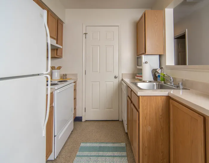 Bright kitchen with wooden cabinetry, modern appliances, and ample countertop space.