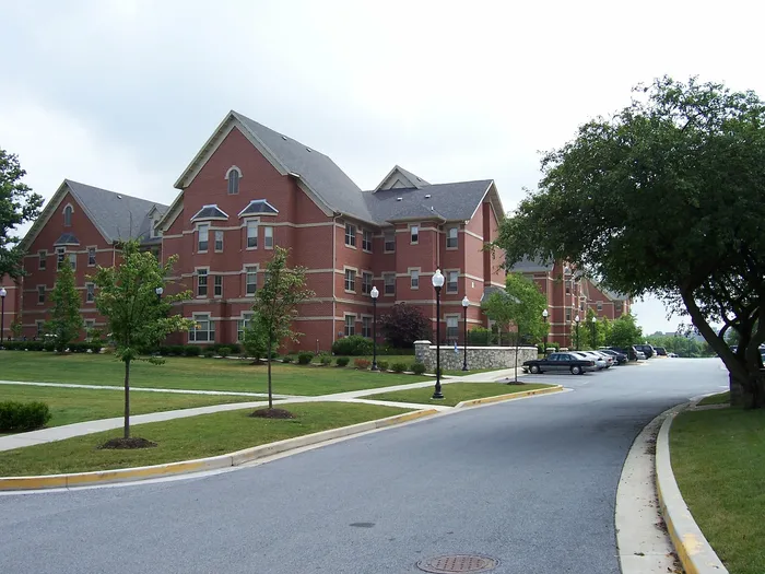 Impressive brick apartment complex with well-maintained landscaping and ample parking space.