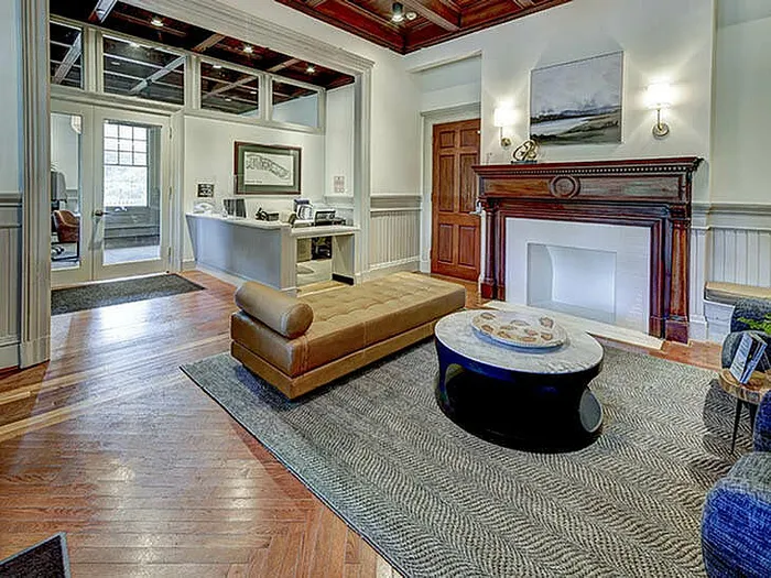 Sophisticated living room with plush seating, a classic fireplace, and chic decor.