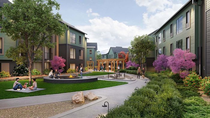 Lush courtyard view of a modern apartment complex featuring vibrant landscaping, communal fire pit, and relaxed residents enjoying the serene atmosphere.