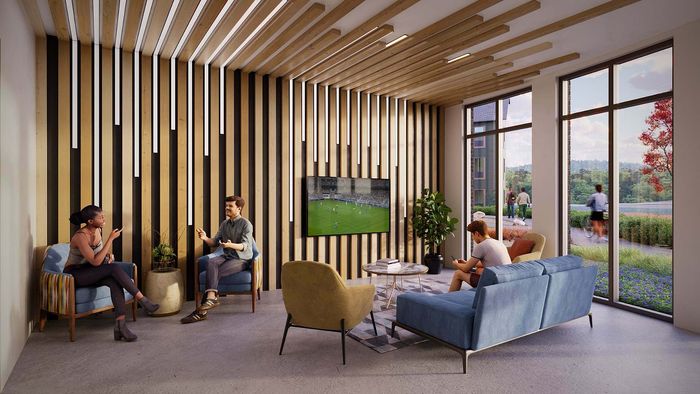 Chic communal lounge with modern decor, featuring stylish seating, a large TV, and floor-to-ceiling windows with scenic views.
