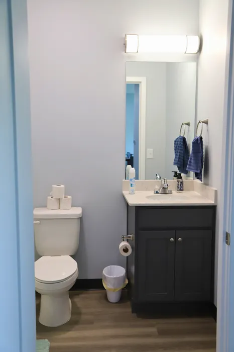 Sleek and modern bathroom with elegant vanity, bright lighting, and stylish flooring.