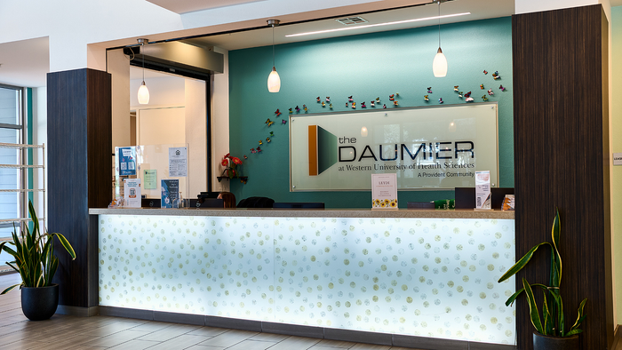 Inviting lobby area with modern decor, featuring a sleek reception desk, elegant lighting, and vibrant wall art.