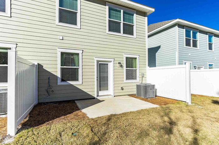 Townhome back yard with patio on sunny day
