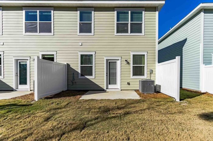 Townhome back yard with patio on sunny day