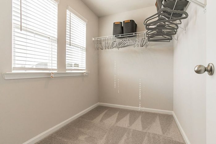 walk in closet with windows