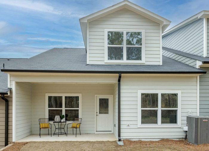 back exterior of cottage with patio