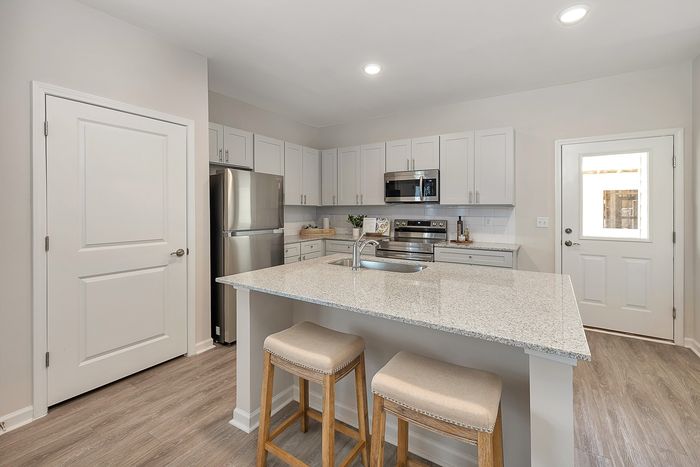 Kitchen with stainless steel appliances and white cabinets
