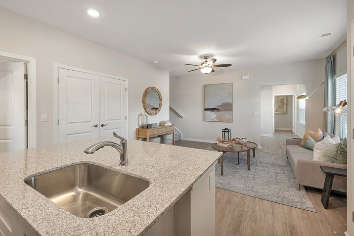 Kitchen sink with view of furnished living room