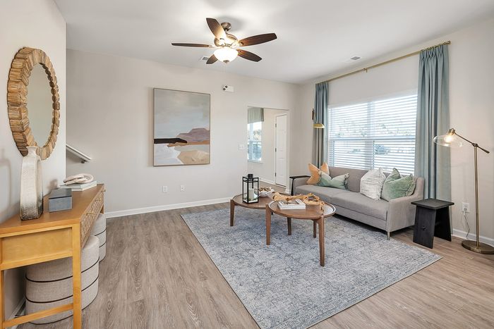 Furnished living room with rug, couch, and one window
