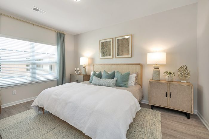 Furnished bedroom with one window, bed and bedside tables