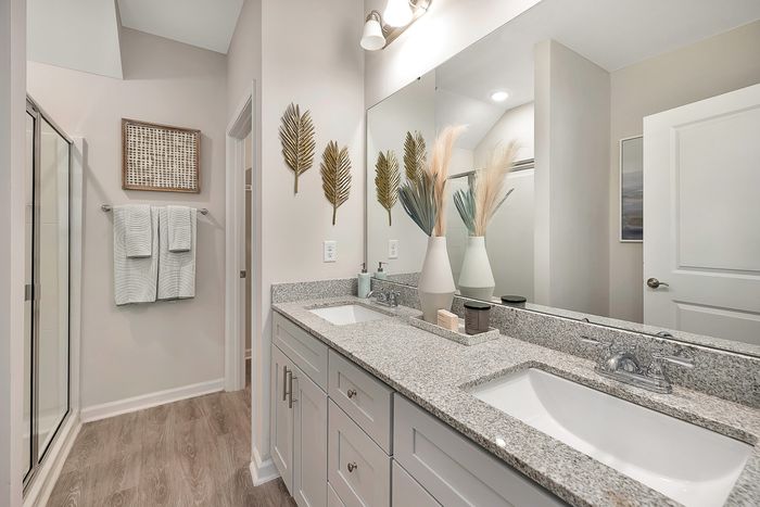 Bathroom with two sinks and large mirror above