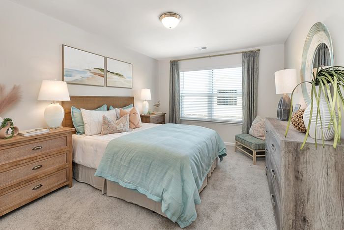 Furnished bedroom with one window, built in ceiling light, bed and bedside tables