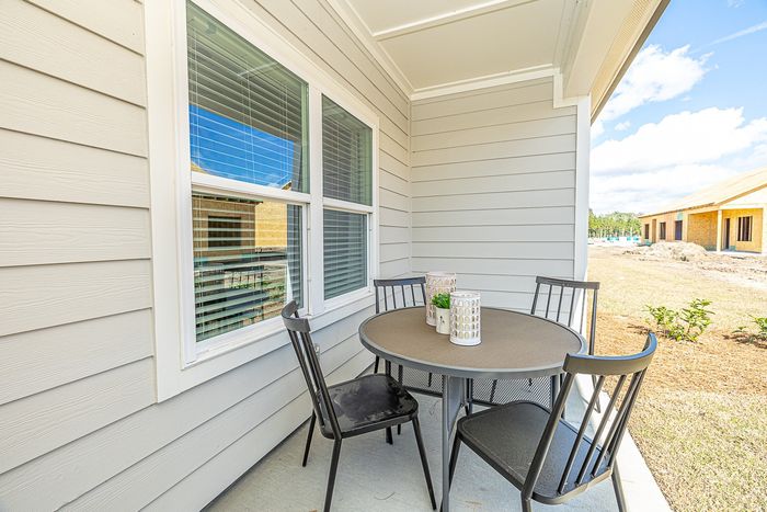 Dog-Friendly Homes in Brunswick, GA - Covey Homes Fox Run -Covered Concrete Patio Connected to Back of Home and Patio Furniture