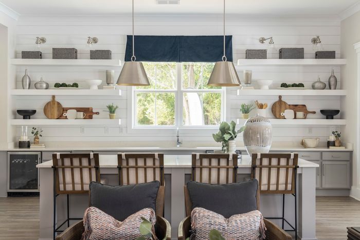 furnished kitchen area with appliances, island and chairs