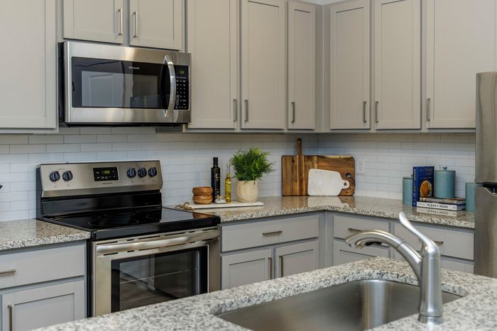 furnished kitchen area with island and appliances in single-family home