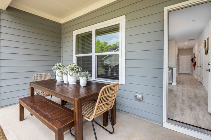 furnished patio area of backyard and exterior home on sunny day