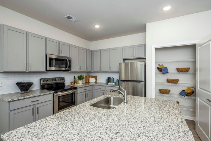 furnished kitchen area with island and appliances in single-family home
